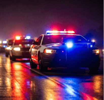 Police cars with emergency lights at night